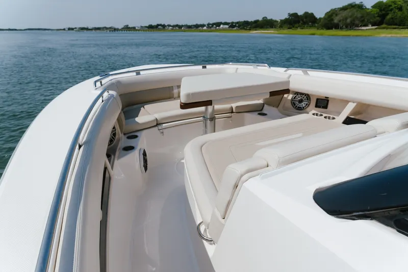Slide: The Image of 2023 Boston Whaler 350 Realm boat interior with luxurious seating and scenic water view. - 8