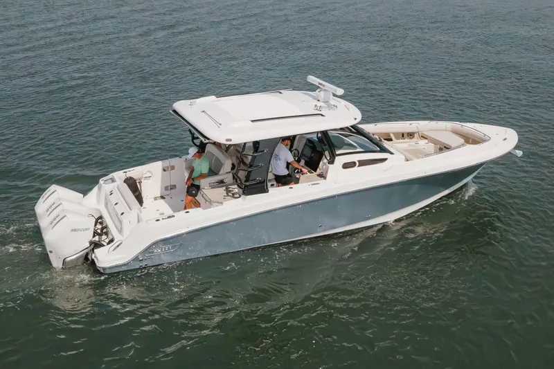 Slide: The Image of 2023 Boston Whaler 350 Realm cruising on open water, showcasing sleek design and powerful engines. - 20