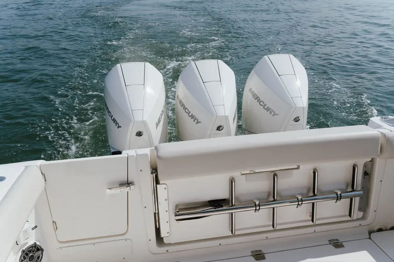 Slide: The Image of 2023 Boston Whaler 350 Realm with triple Mercury engines on water. - 24