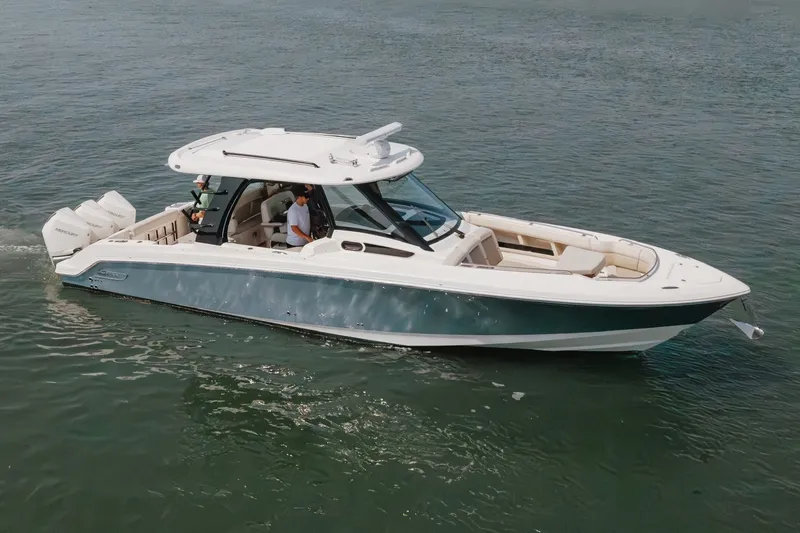 The Image of 2023 Boston Whaler 350 Realm cruising on calm waters, showcasing sleek design and powerful engines. - 0