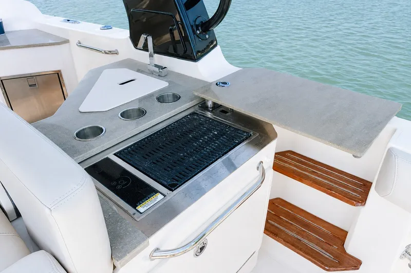Slide: The Image of Outdoor kitchen on 2023 Boston Whaler 350 Realm boat with grill and sink. - 14