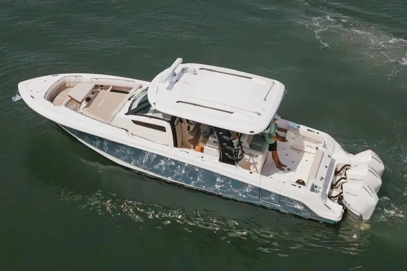 Slide: The Image of 2023 Boston Whaler 350 Realm boat cruising on open water, aerial view. - 18