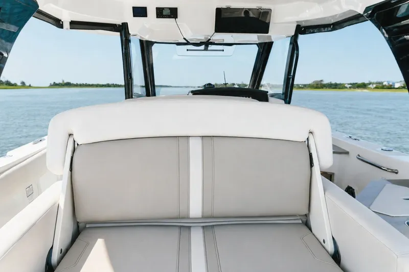 Slide: The Image of 2023 Boston Whaler 350 Realm interior with comfortable seating on open water. - 23