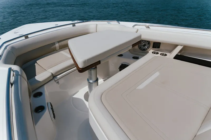 Slide: The Image of Luxurious seating area on 2023 Boston Whaler 350 Realm boat, featuring a central table. - 9