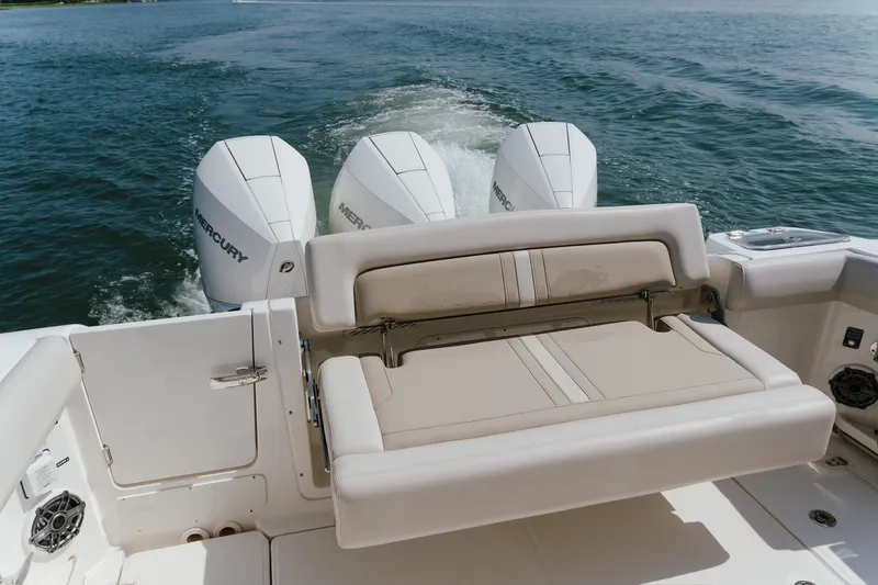 Slide: The Image of 2023 Boston Whaler 350 Realm with triple Mercury engines on open water. - 17