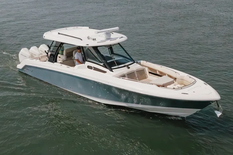 Slide: The Image of 2023 Boston Whaler 350 Realm cruising on open water, showcasing sleek design and luxury features. - 3