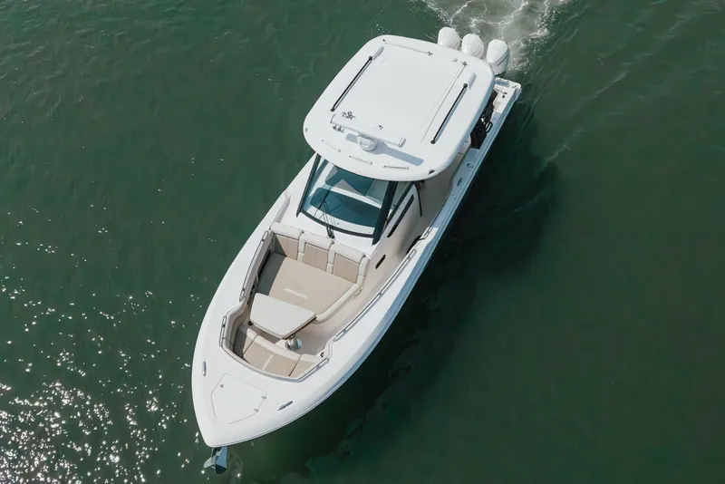 Slide: The Image of 2023 Boston Whaler 350 Realm cruising on open water, aerial view. - 6