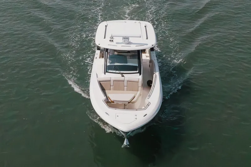 Slide: The Image of 2023 Boston Whaler 350 Realm cruising on open water, aerial view. - 1