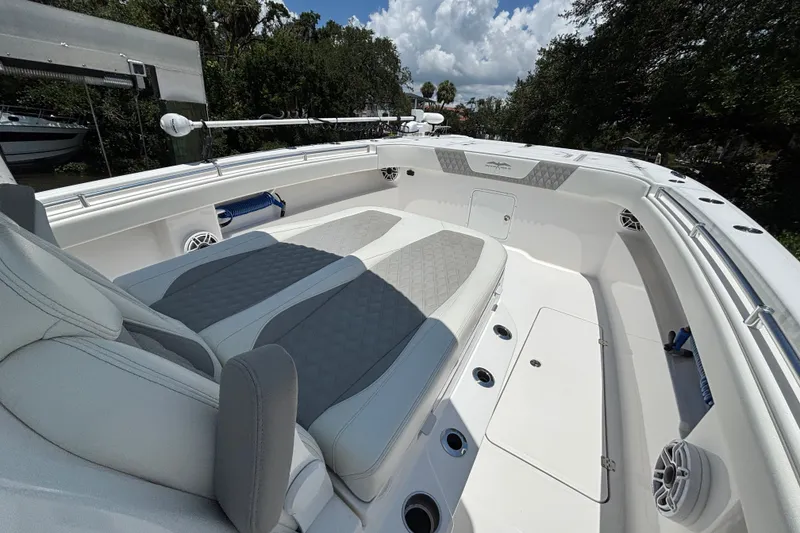 Slide: The Image of 2024 Invincible 33 Catamaran interior with cushioned seating and sleek design. - 25