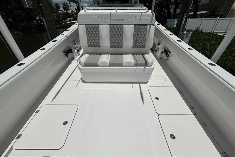 Slide: The Image of 2024 Invincible 33 Catamaran interior with cushioned seating and spacious deck layout. - 48
