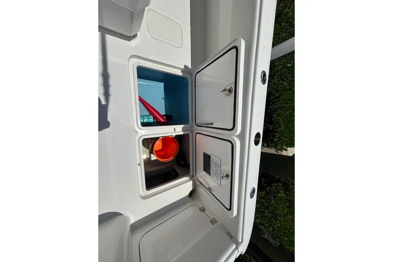 Slide: The Image of 2024 Invincible 33 Catamaran storage compartments with open hatches and visible equipment. - 43