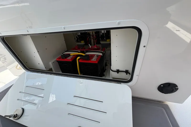 Slide: The Image of Battery compartment of 2024 Invincible 33 Catamaran, showcasing dual batteries and wiring. - 41