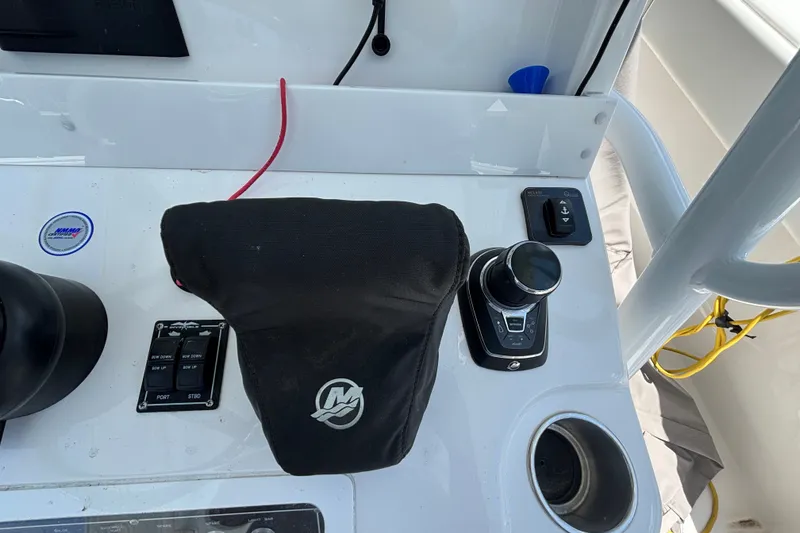 Slide: The Image of Control panel of 2024 Invincible 33 Catamaran with joystick and covered throttle. - 38