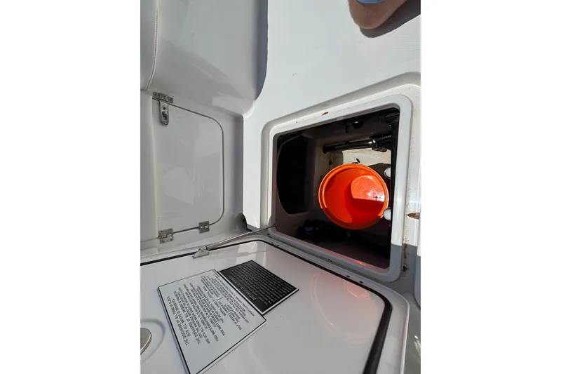 Slide: The Image of Storage compartment on 2024 Invincible 33 Catamaran, featuring an orange bucket inside. - 42
