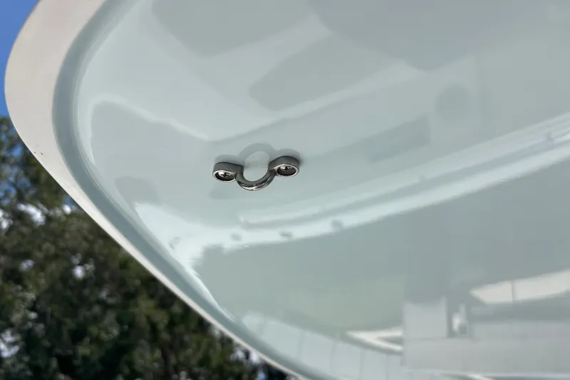 Slide: The Image of Close-up of a 2024 Invincible 33 Catamaran's sleek hull design with a metal fitting. - 9
