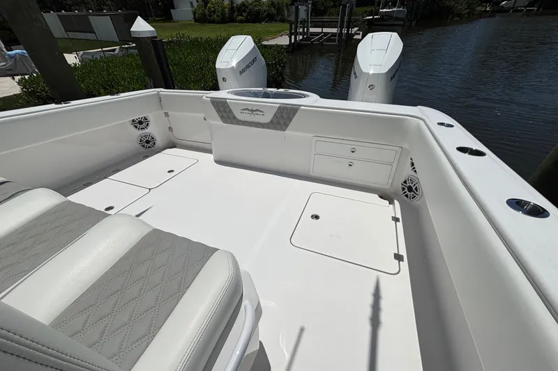 Slide: The Image of 2024 Invincible 33 Catamaran boat interior with seating and storage compartments. - 54