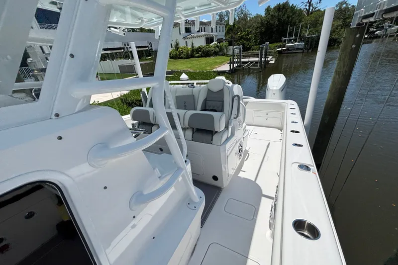 Slide: The Image of 2024 Invincible 33 Catamaran with sleek seating and modern design docked by the water. - 16