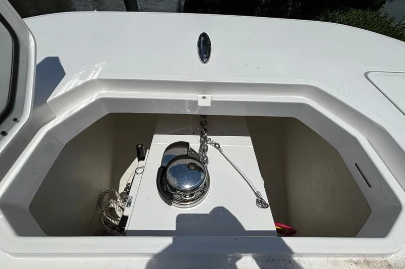 Slide: The Image of Anchor compartment of 2024 Invincible 33 Catamaran with chain and winch. - 19