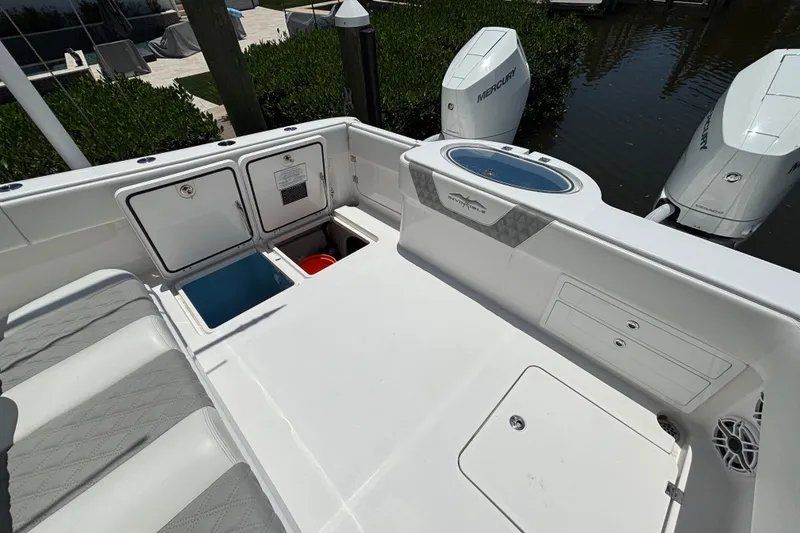 Slide: The Image of 2024 Invincible 33 Catamaran deck with storage compartments and Mercury outboard engines. - 8