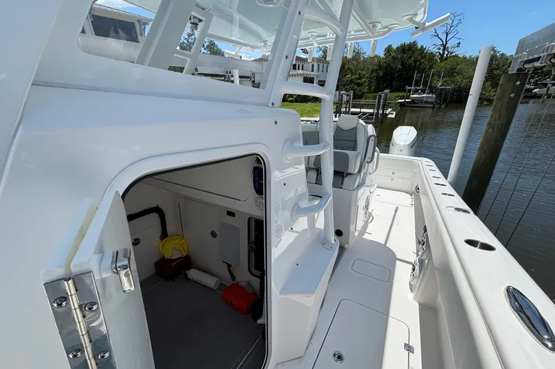 Slide: The Image of 2024 Invincible 33 Catamaran boat interior with open cabin door and seating area. - 15