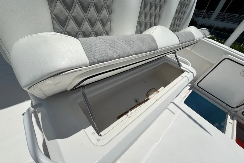 Slide: The Image of 2024 Invincible 33 Catamaran seat storage compartment with open lid, showcasing interior space. - 35