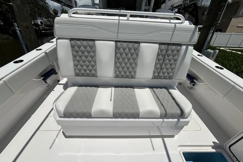 Slide: The Image of 2024 Invincible 33 Catamaran with luxurious diamond-stitched seating in white and gray. - 45