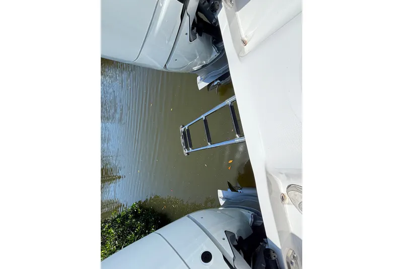 Slide: The Image of Rear view of 2024 Invincible 33 Catamaran with ladder and twin engines. - 57