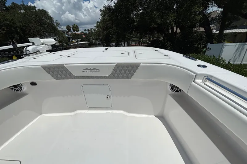 Slide: The Image of 2024 Invincible 33 Catamaran boat interior, featuring sleek white design and spacious deck. - 18