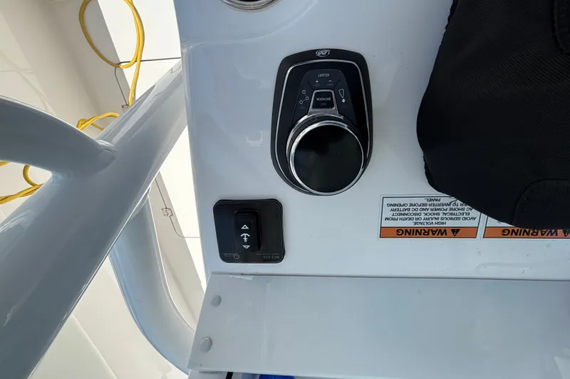 Slide: The Image of Control panel of 2024 Invincible 33 Catamaran with joystick and warning labels. - 33
