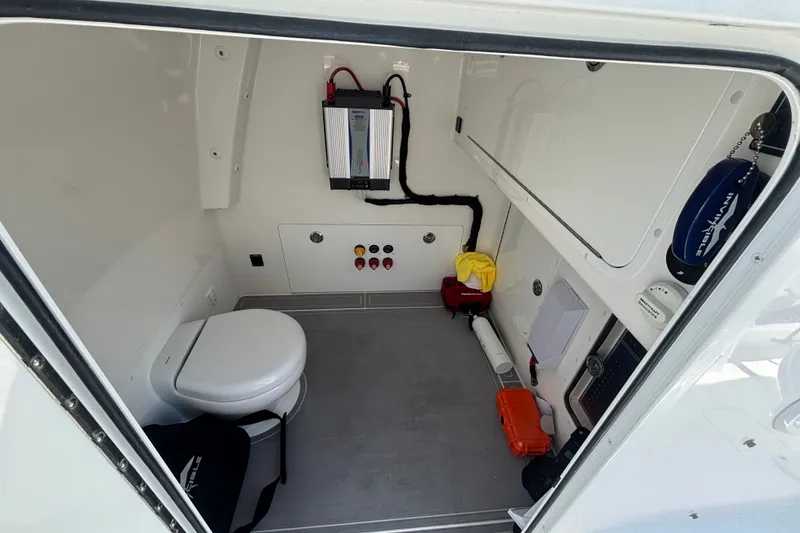 Slide: The Image of 2024 Invincible 33 Catamaran interior cabin with toilet and storage compartments. - 51