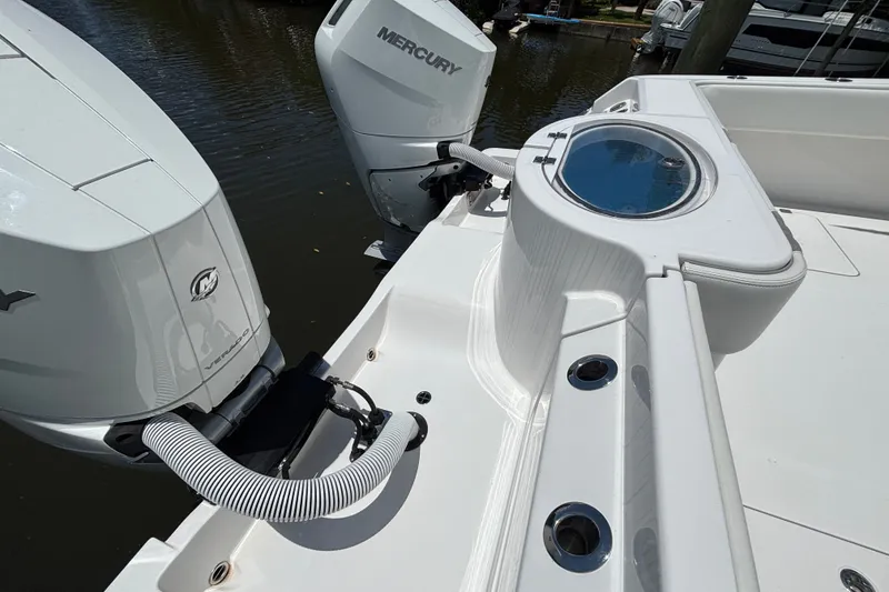 Slide: The Image of 2024 Invincible 33 Catamaran with dual Mercury outboard engines and livewell on deck. - 56