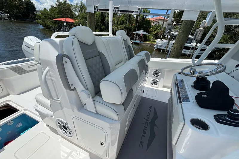 Slide: The Image of 2024 Invincible 33 Catamaran interior with luxurious seating and modern helm controls. - 36