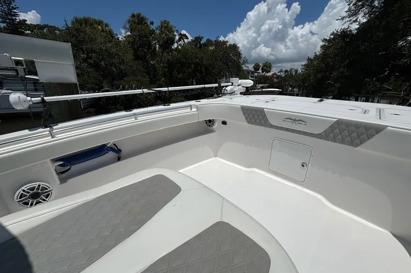 Slide: The Image of 2024 Invincible 33 Catamaran interior with cushioned seating and storage compartment. - 22