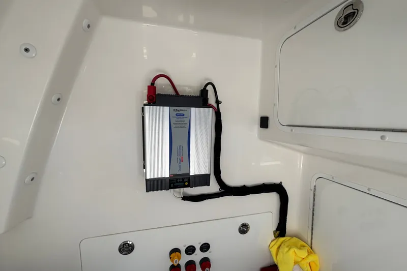 Slide: The Image of Electrical system inside 2024 Invincible 33 Catamaran, featuring a mounted power inverter. - 53
