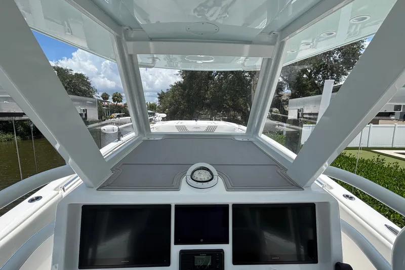 Slide: The Image of 2024 Invincible 33 Catamaran helm with modern navigation displays and panoramic view. - 34