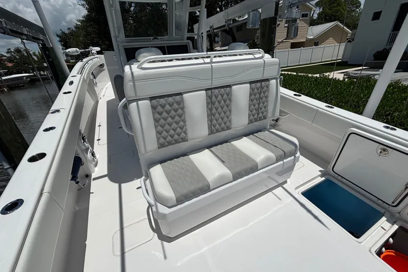 Slide: The Image of 2024 Invincible 33 Catamaran interior with cushioned seating and storage compartments. - 2