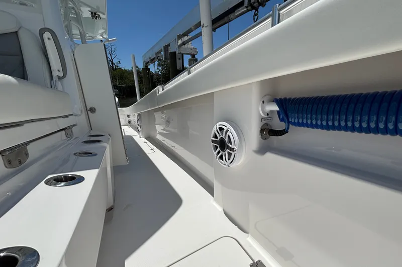 Slide: The Image of 2024 Invincible 33 Catamaran interior with rod holders and marine speaker. - 14