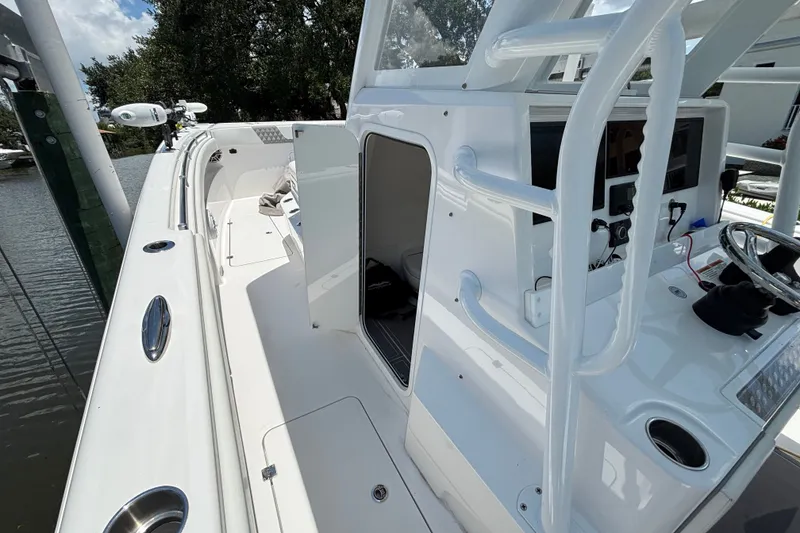 Slide: The Image of 2024 Invincible 33 Catamaran interior with helm, seating, and modern controls. - 28
