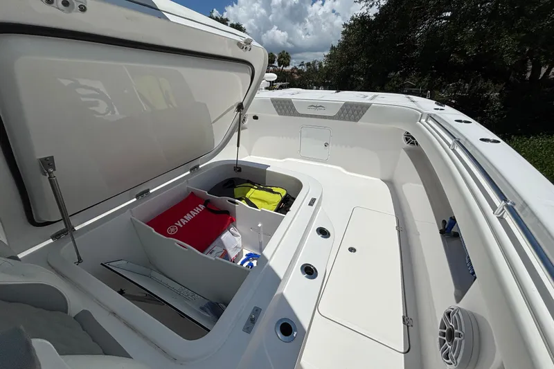 Slide: The Image of 2024 Invincible 33 Catamaran storage compartment with Yamaha gear and accessories. - 17