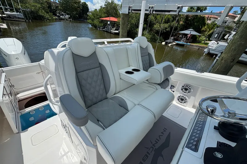 Slide: The Image of Luxurious seating on 2024 Invincible 33 Catamaran, featuring plush upholstery and cup holders. - 40