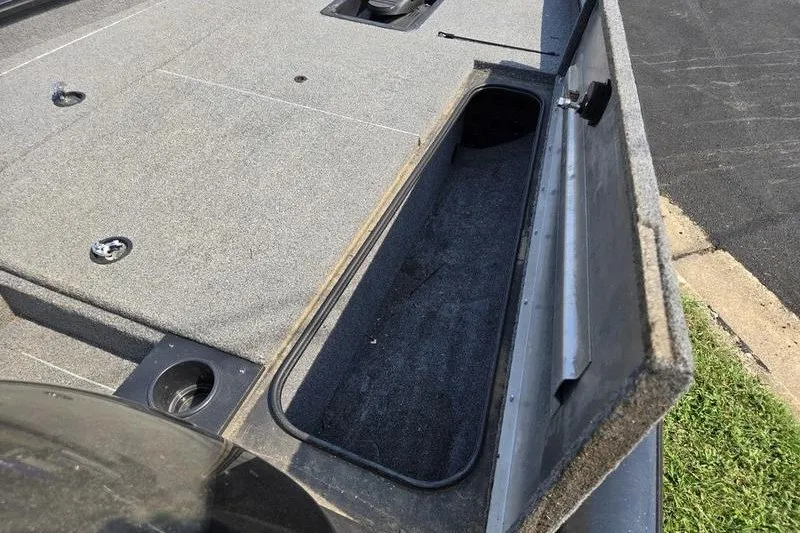 Slide: The Image of 2024 Tracker Pro Team 175 TXW boat storage compartment with open lid, showcasing interior space. - 15