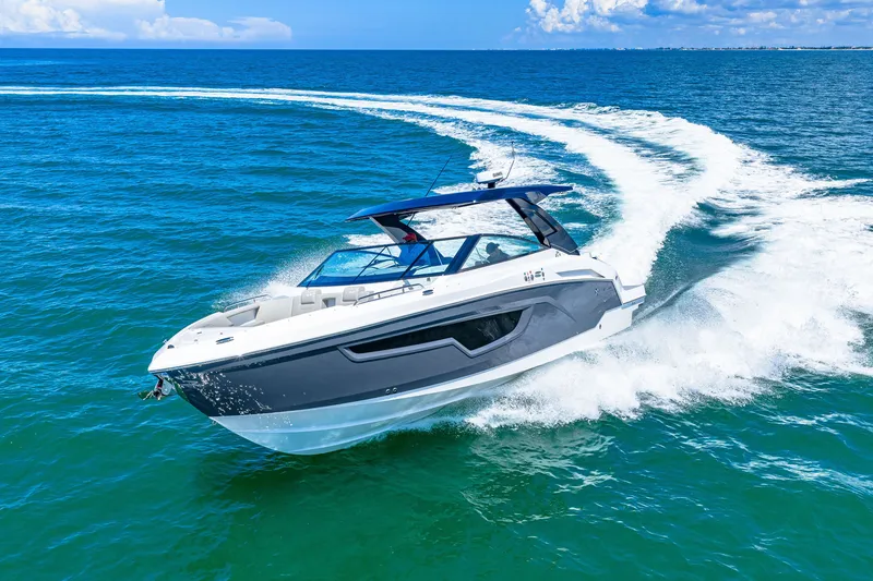 Slide: The Image of A modern motorboat speeding across the blue sea, featuring a sleek white and gray design. - 19