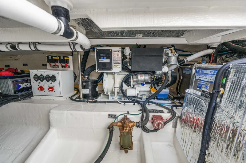 Slide: The Image of The engine room of a 2027 Cruisers Yachts 34 GLS OB, featuring engines and technical equipment. - 49
