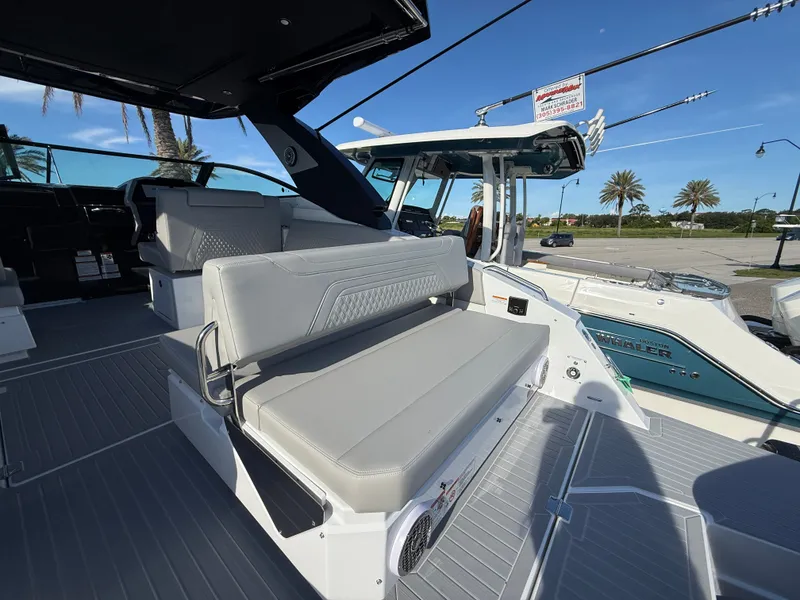Slide: The Image of The image shows the deck of a 2027 Cruisers Yachts 34 GLS OB with gray seating. - 33