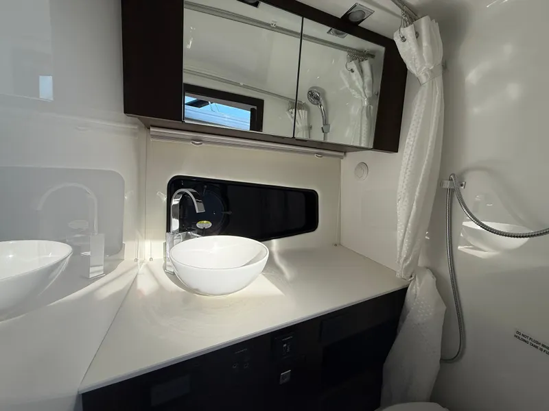 Slide: The Image of The image shows a modern yacht bathroom with a sink and mirror. - 27