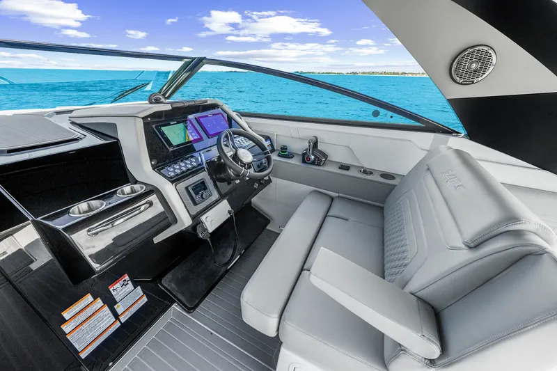 Slide: The Image of The cockpit of the 2027 Cruisers Yachts 34 GLS OB features a modern helm with dual screens and comfortable seating. - 31