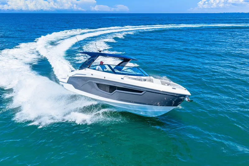 Slide: The Image of A modern motorboat speeds across the blue sea, leaving a white wake behind. - 14
