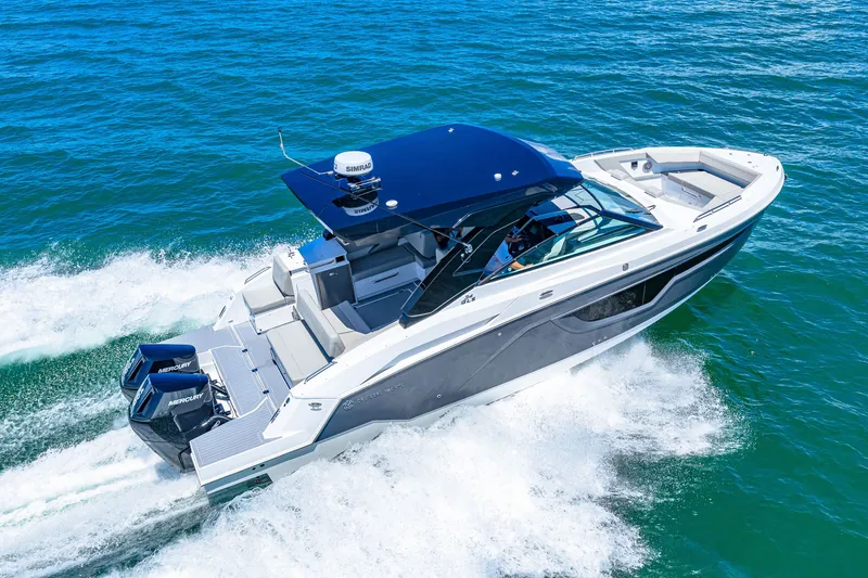 Slide: The Image of A modern motorboat with a blue canopy speeds across the blue water. - 18
