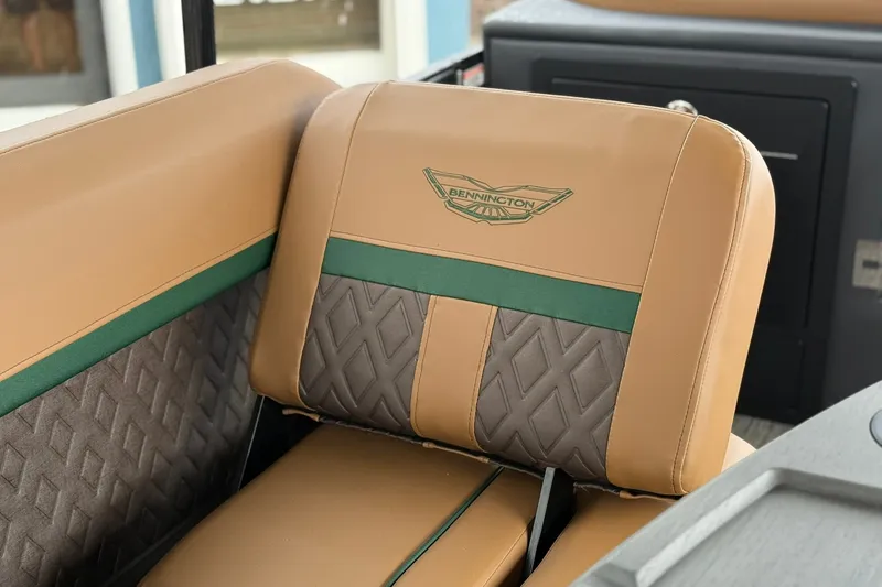 Slide: The Image of 2027 Bennington 24 M Fish and Cruise boat seat with tan and green upholstery. - 5