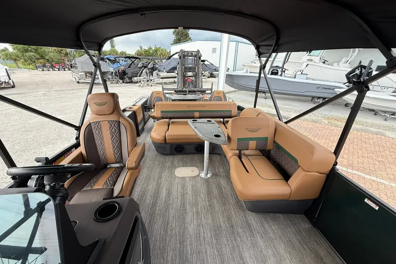 Slide: The Image of 2027 Bennington 24 M Fish and Cruise pontoon boat interior with luxurious seating and helm. - 11